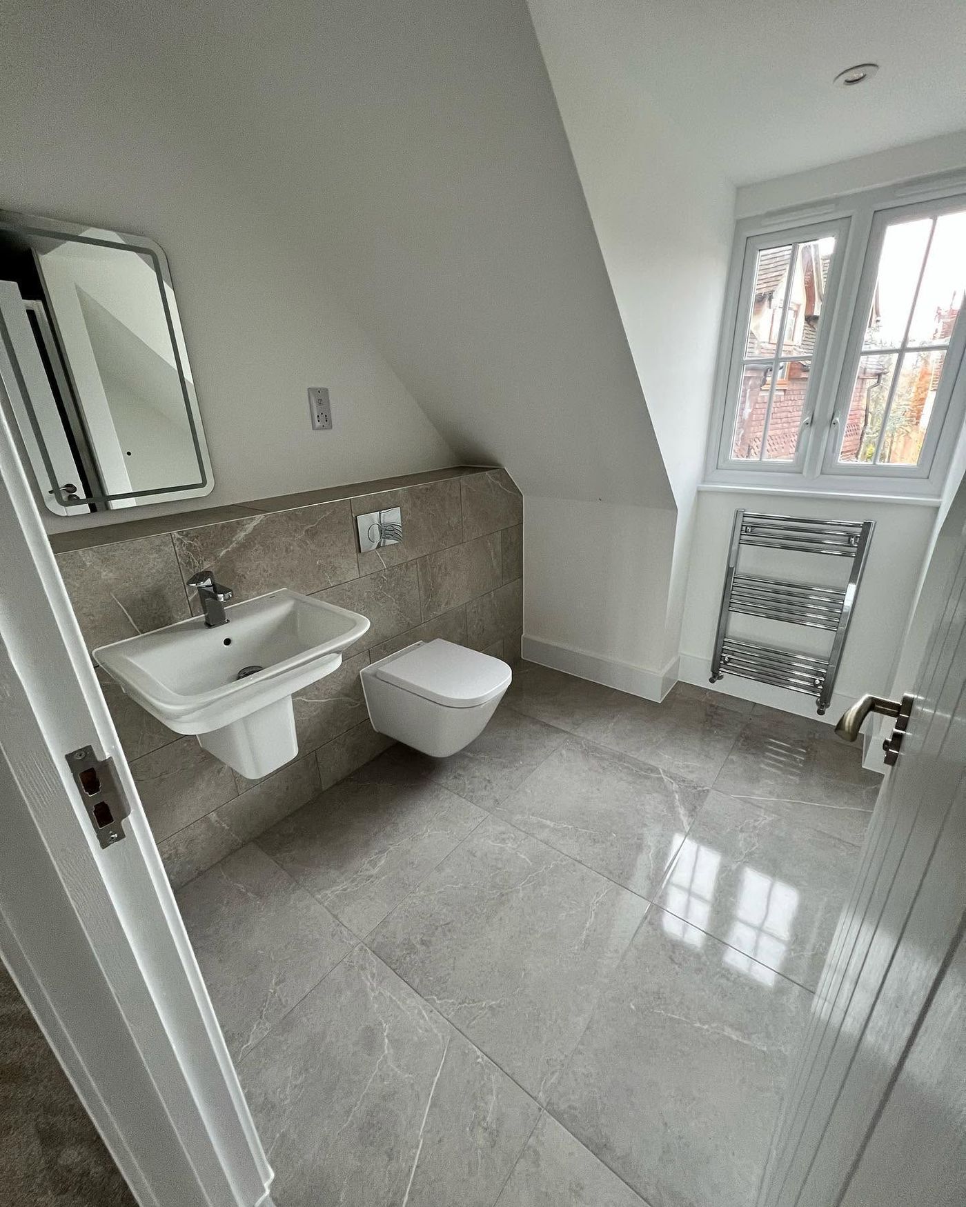 Loft conversion bathroom with wall-hung suite