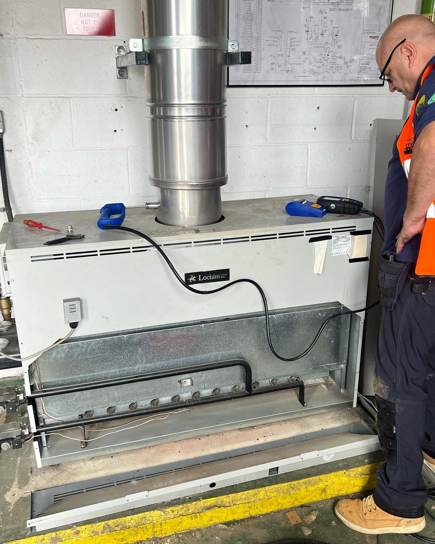 Flow Mate engineer attending a commercial boiler
